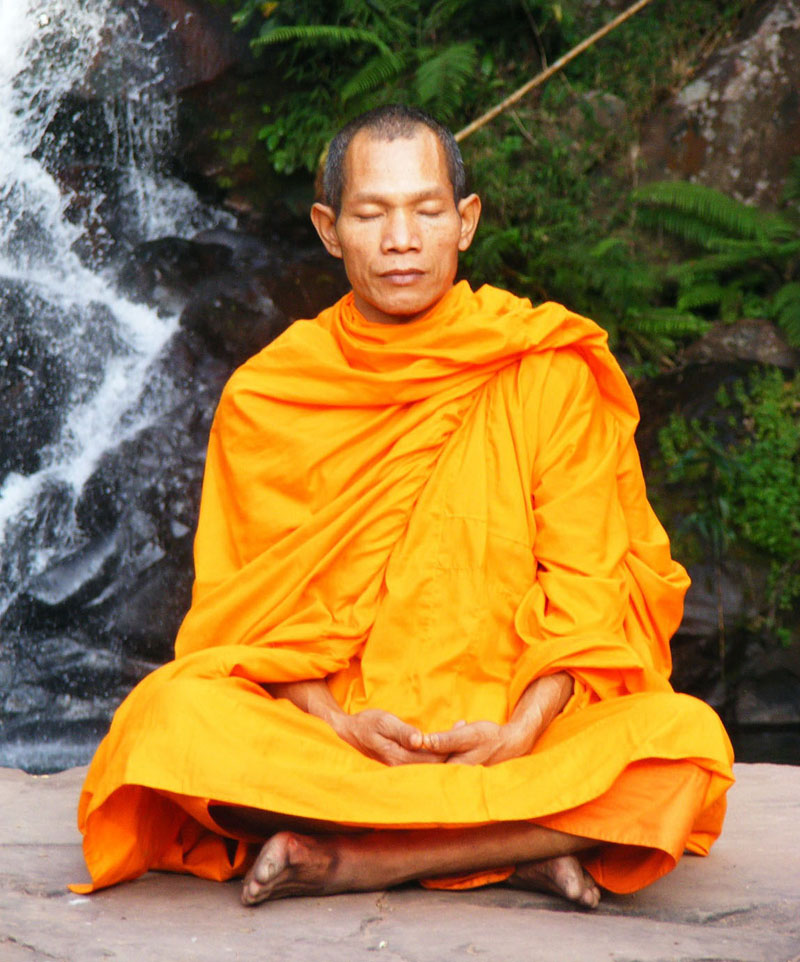 Buddhist monk Meditating in a Waterfall Setting