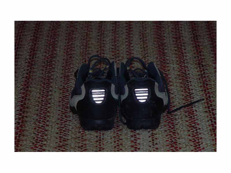 Retroreflectors are clearly visible in a pair of bicycle shoes. Light source is a flash a few centimeters above camera lens.