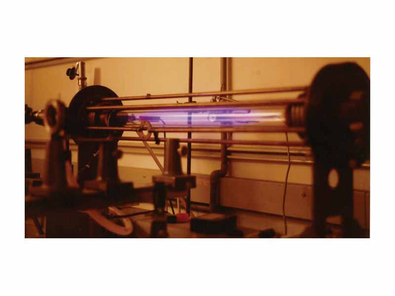 Laboratory scale Z-pinch showing glow from an expanded hydrogen plasma. Pinch and ionisation current flows through the gas and returns via the bars surrounding the plasma vessel.