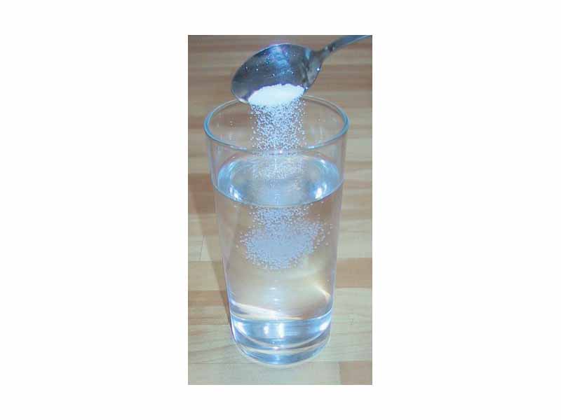Making a saline water solution by dissolving table salt (NaCl) in water